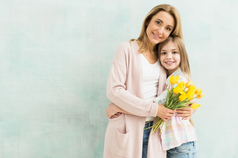 Happy mom and daughter posing for a photo.